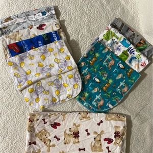 Bundle of homemade burp clothes, pacifier holders, and light swaddle blanket.